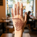 Semi-permanent henna-style floral tattoo applied on the back of a hand