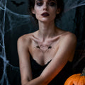 Model wearing black spider temporary tattoos on chest for a Halloween costume look