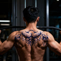 Man wearing a blue winged semi-permanent tattoo across the upper back and shoulders